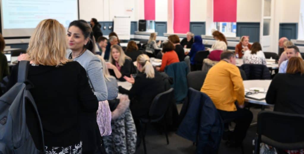 Busy event room showing a GCVS members meeting with people chatting