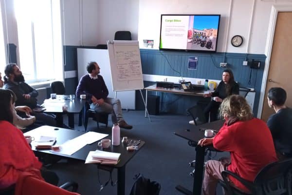Photo of meeting with Gail Murray, Bike for Good presenting a range of offers.