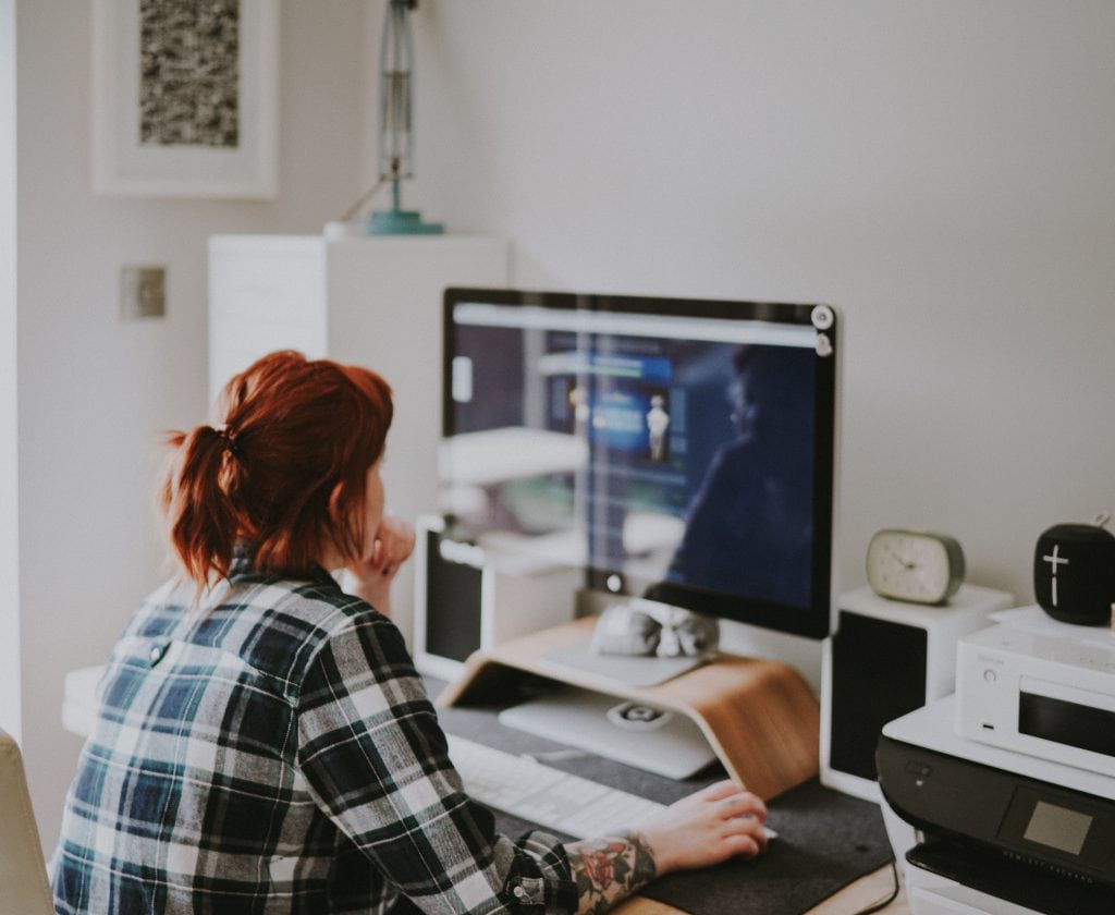 woman working, looking at her computer screen